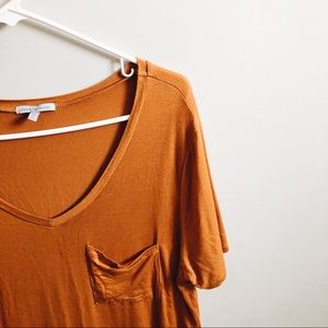 Loose orange shirt.